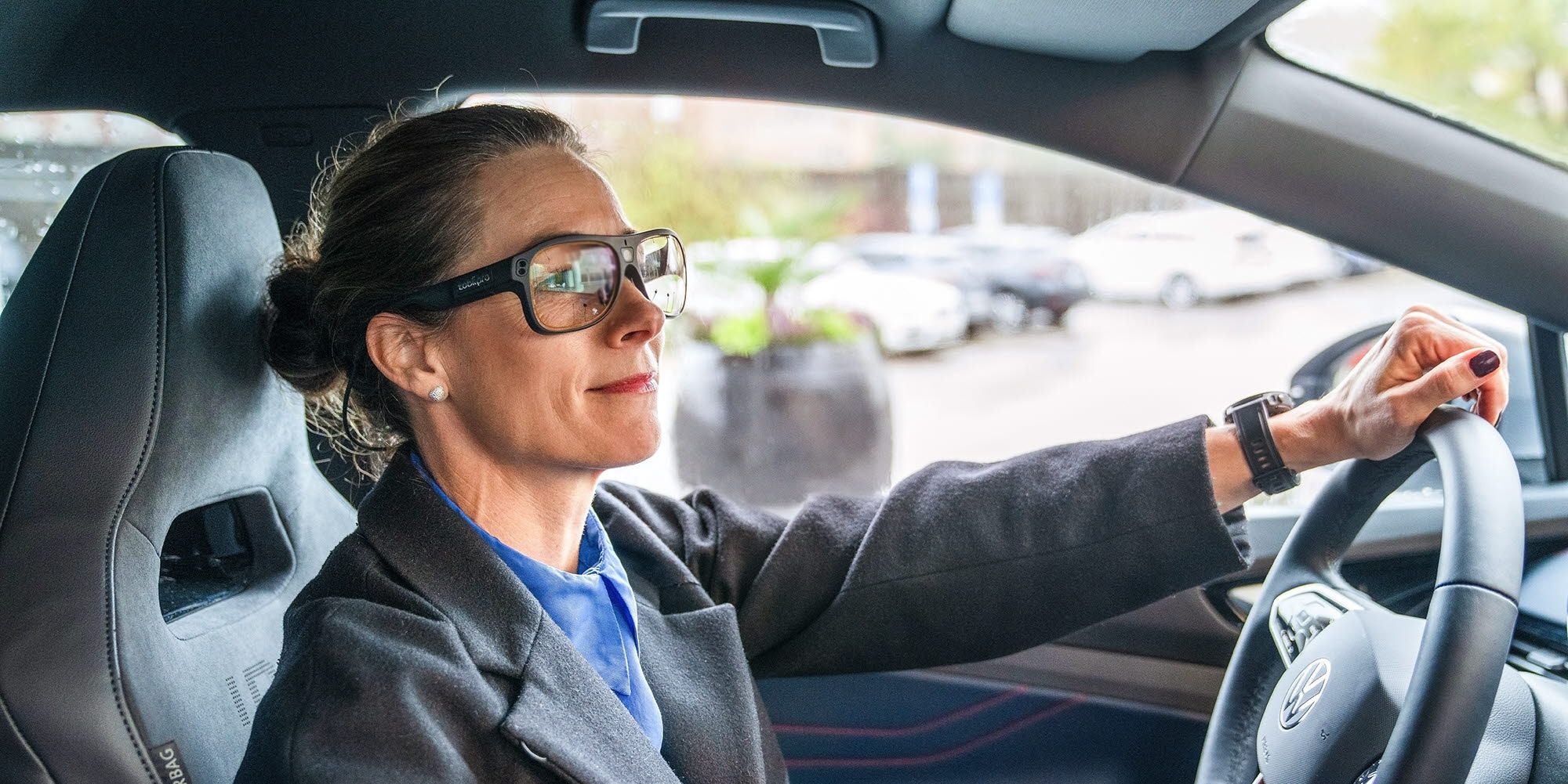 Person driving a car wearing Tobii Pro Glasses 3