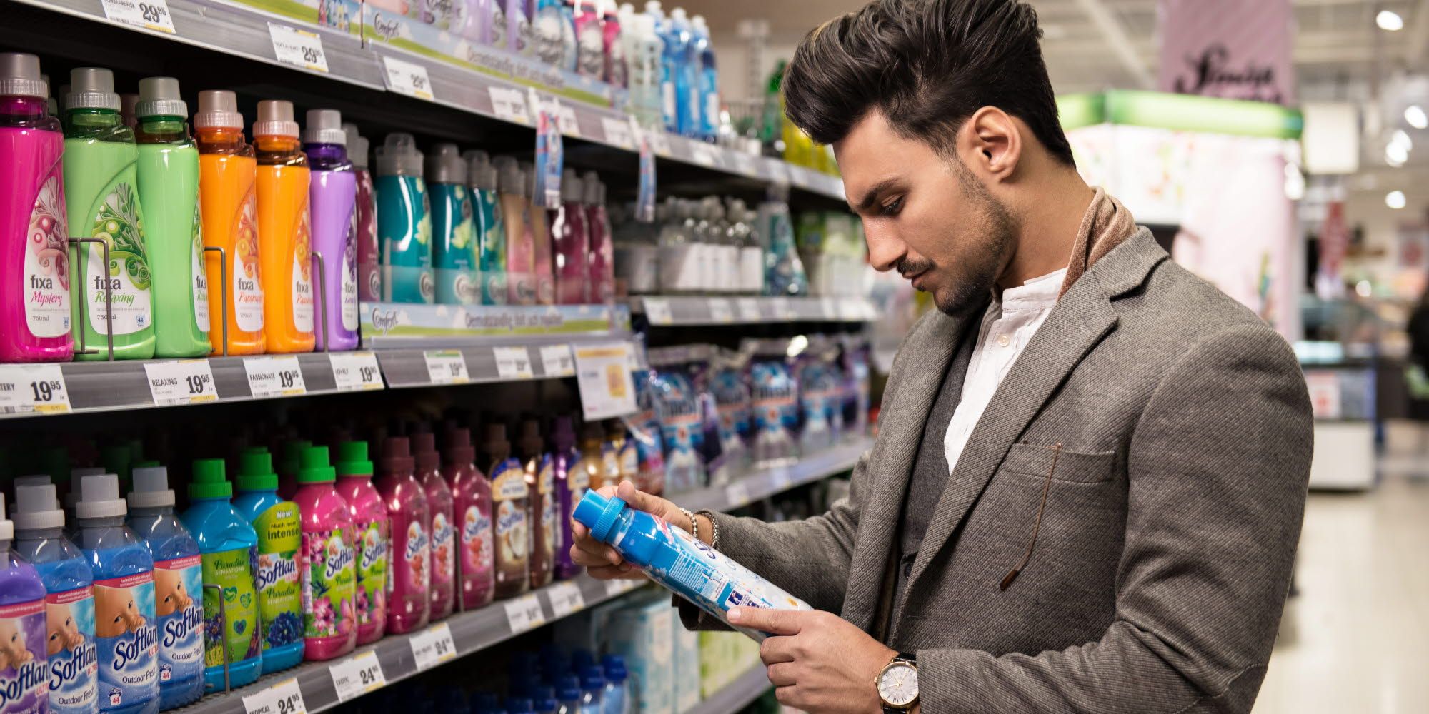 A man in a store looking at packaging