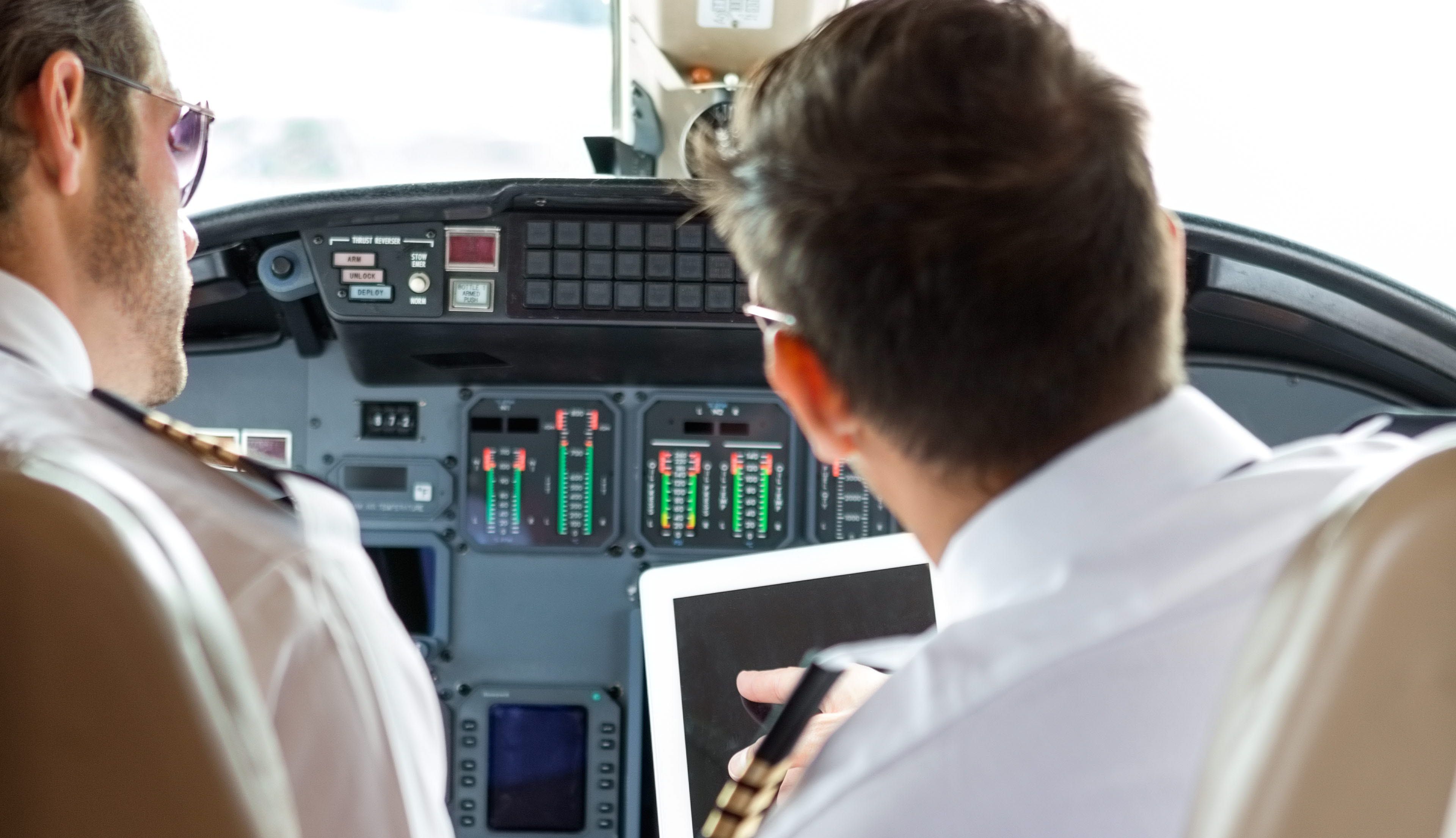 2 pilot doing a safety check in the cockpit