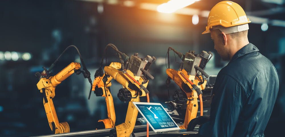 Man operating a computer in a factory.