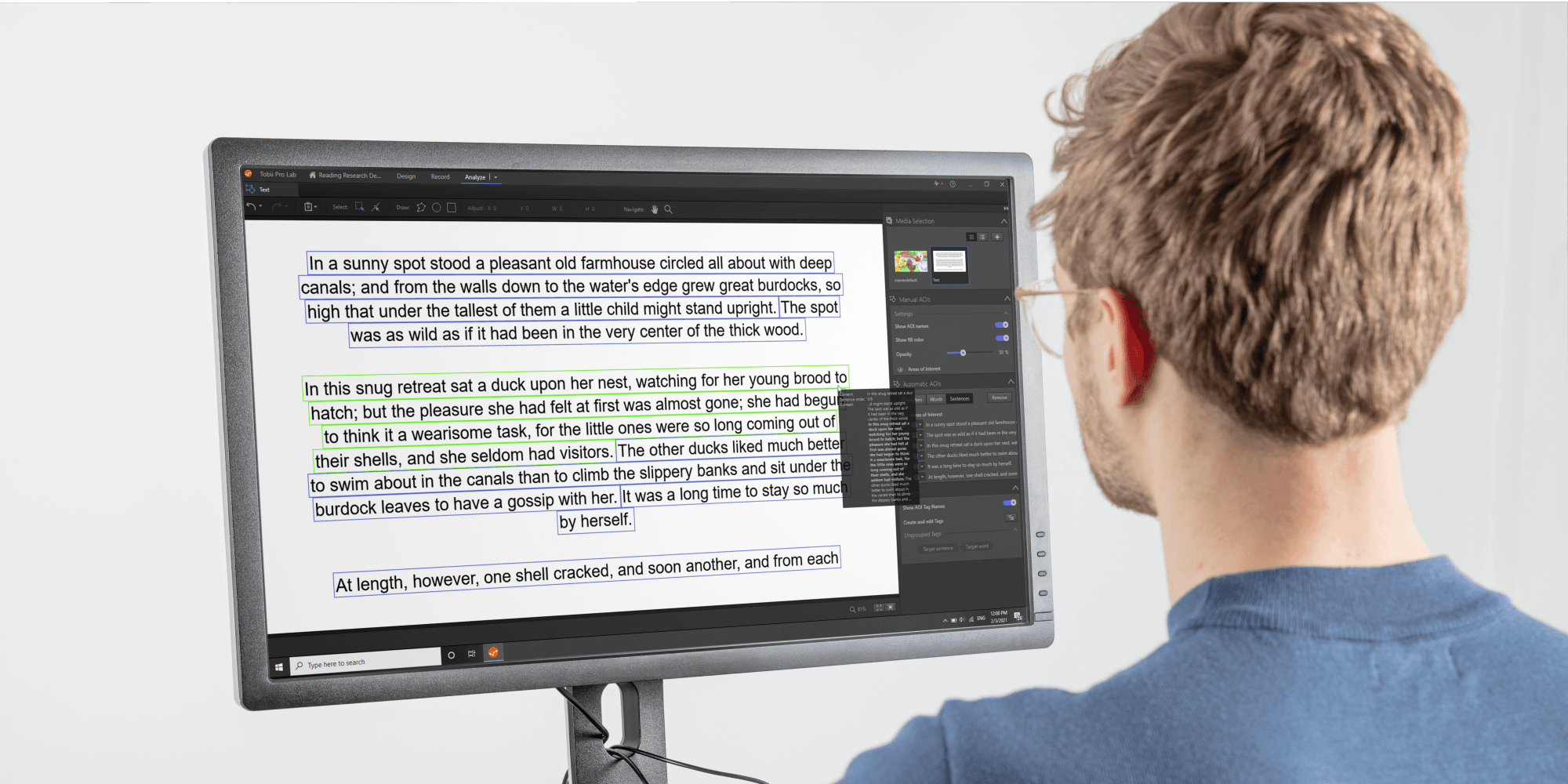 A man reading a text from a desktop screen