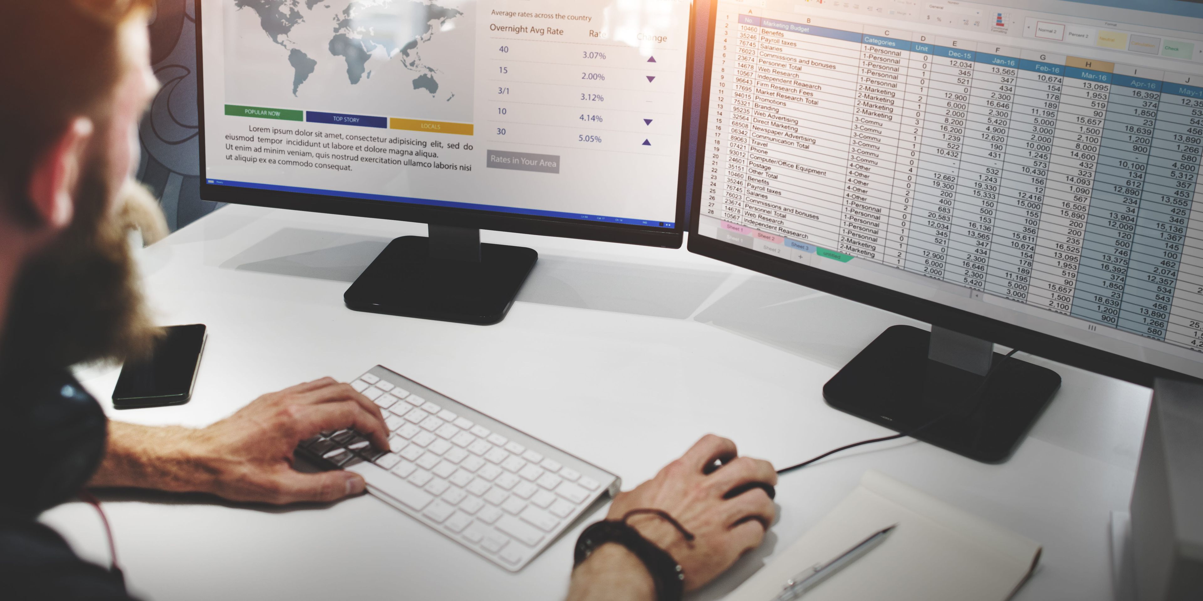 Man working at multiple screens