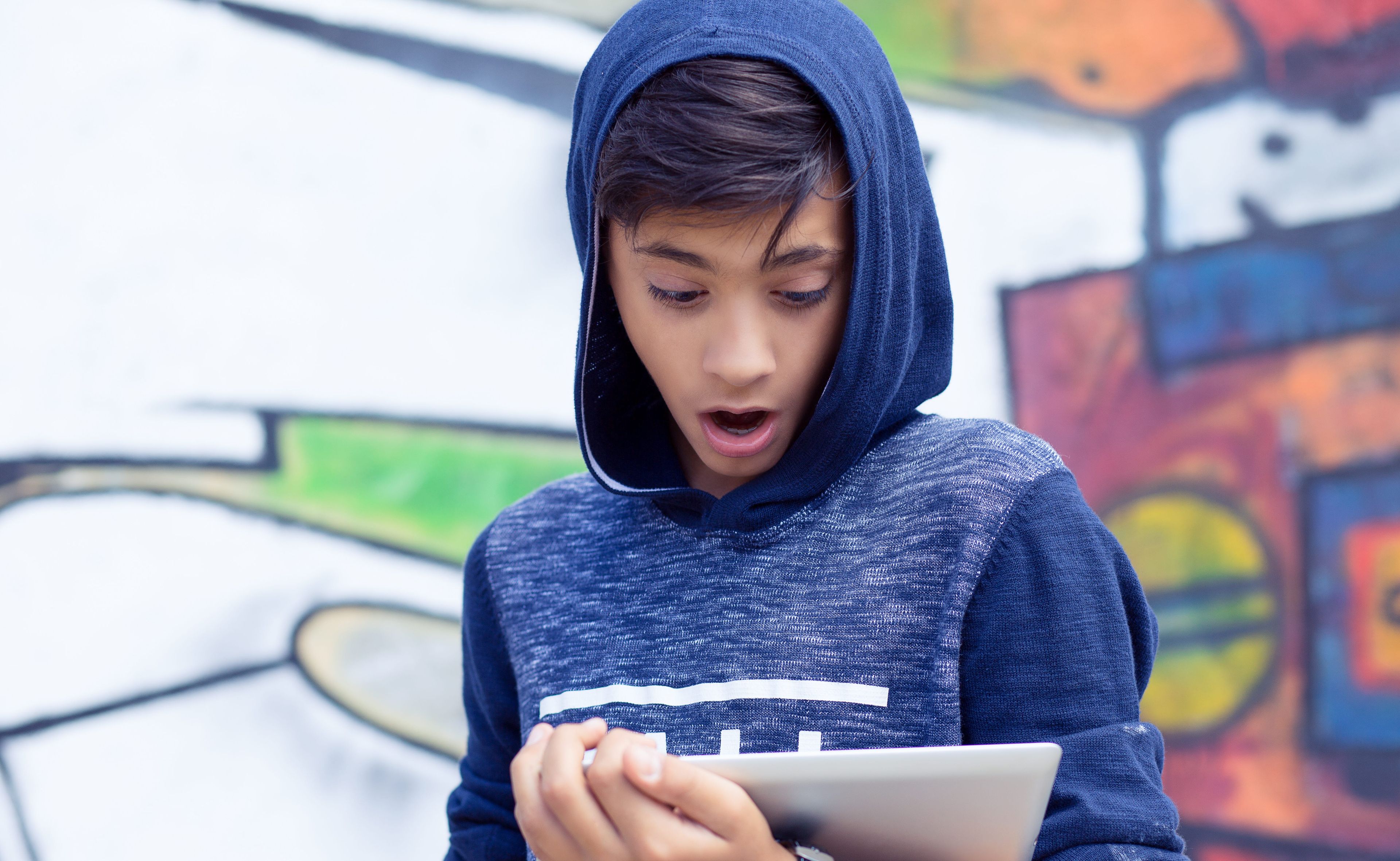 boy looking at a screen surprised