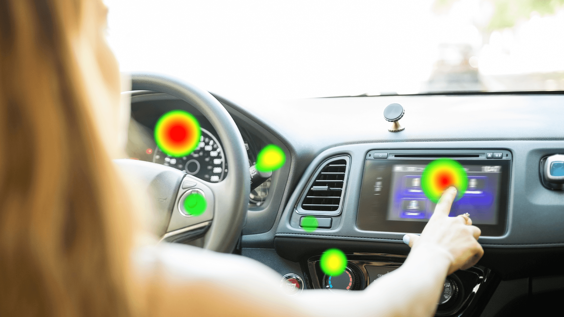 A heat map of the gaze shows a woman touching a navigation system during driving.