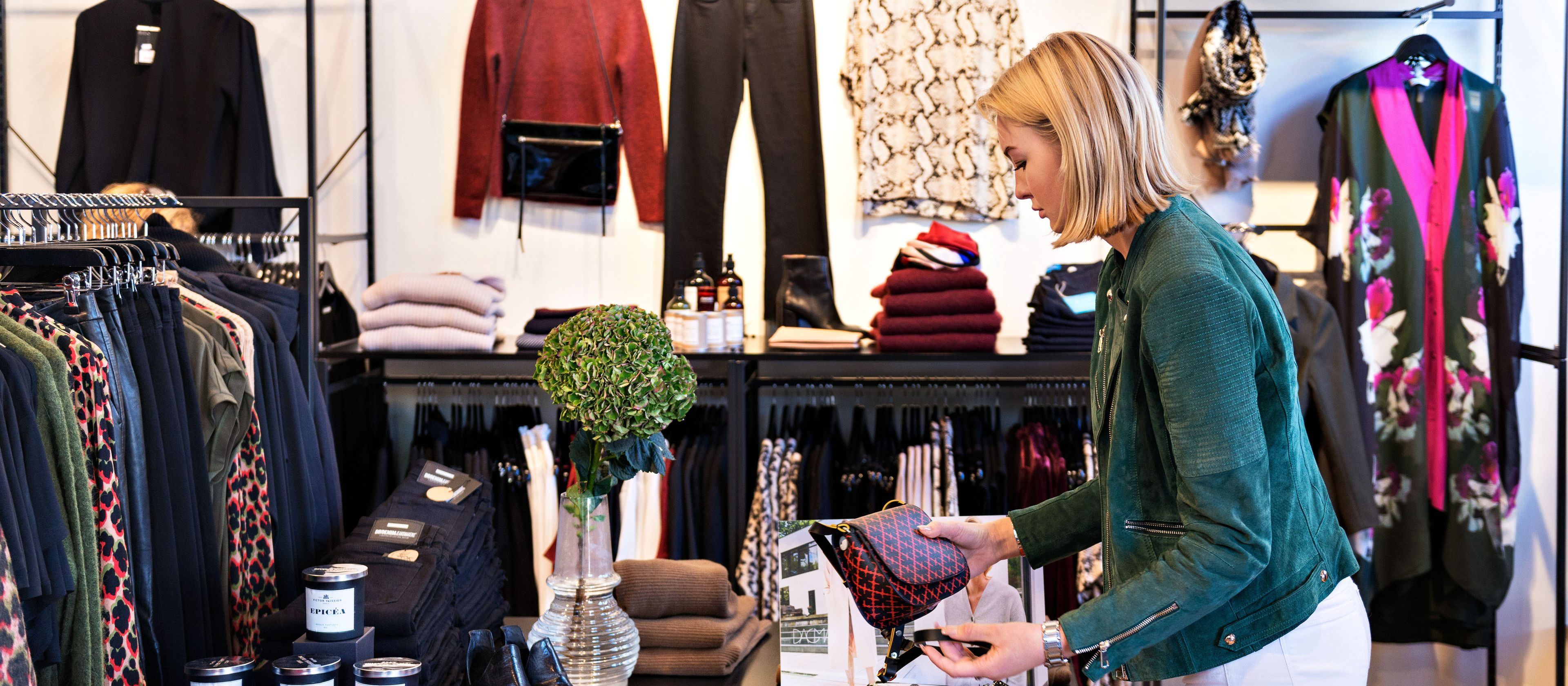 Woman looking at purses in a store