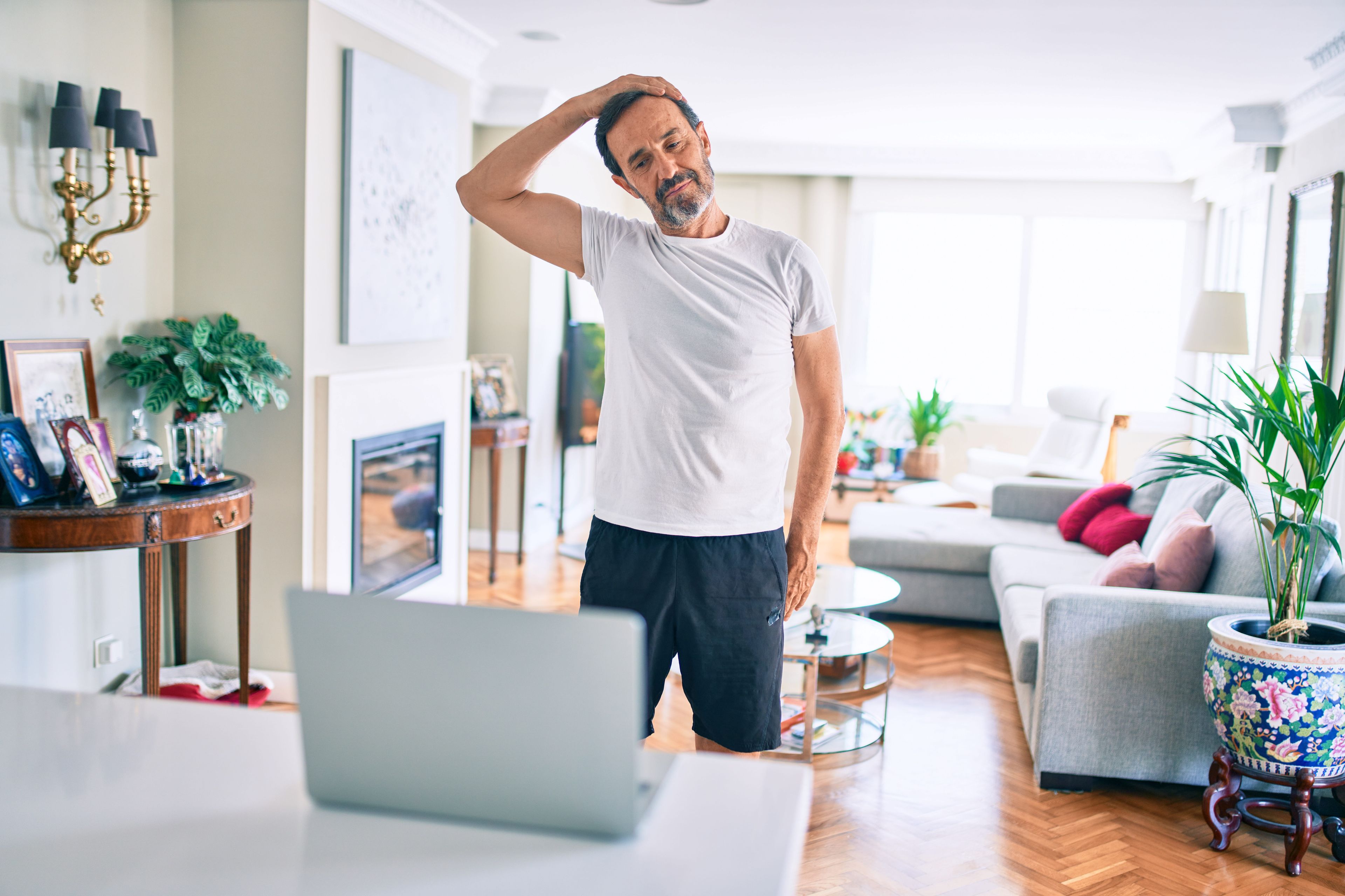 Man stretching after sitting at his laptop