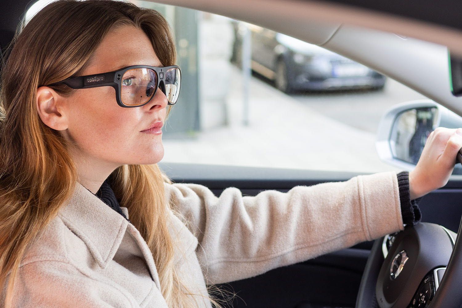 Woman driving a car with Tobii Pro Glasses 3