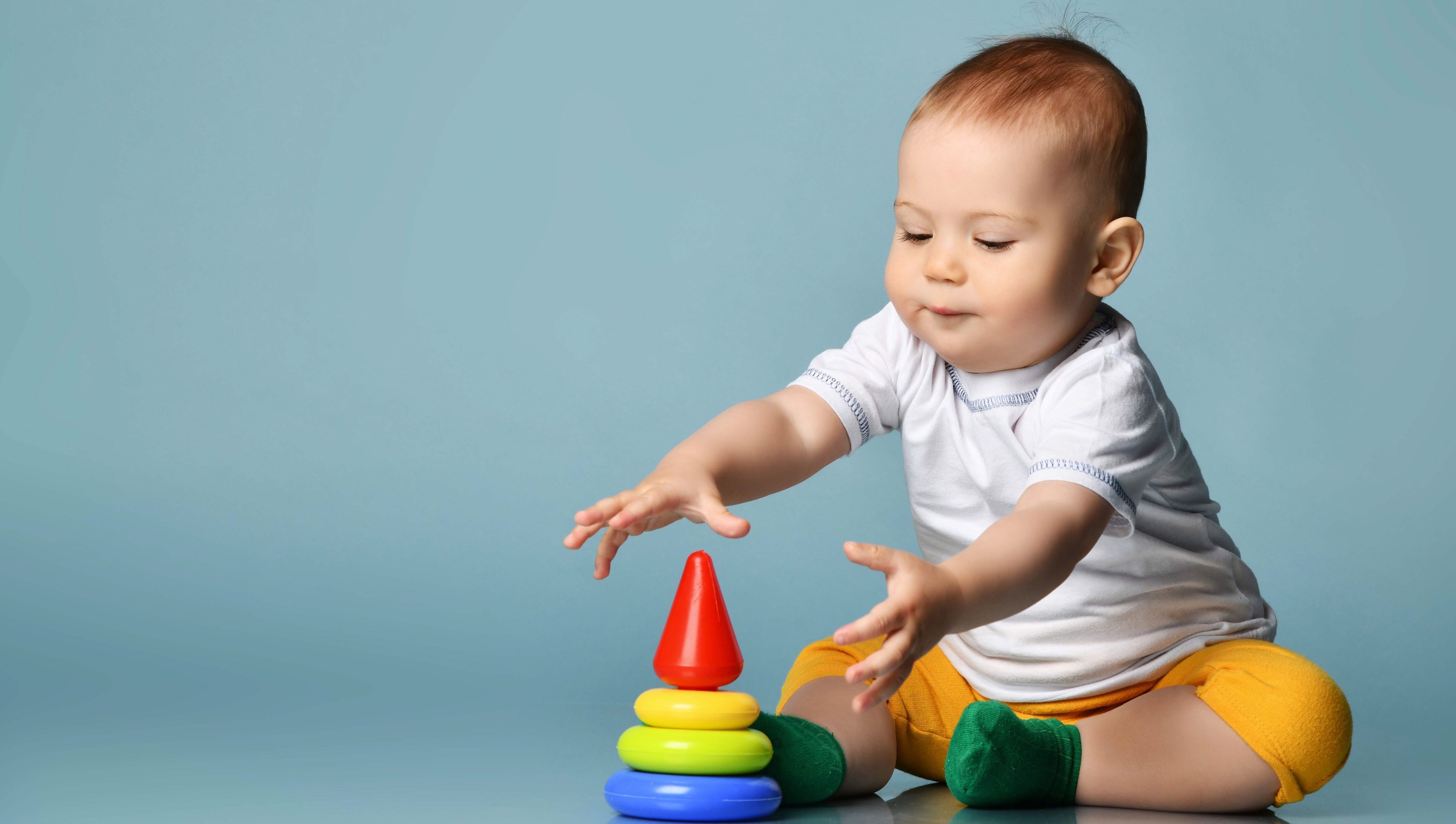 Infant playing with a toy