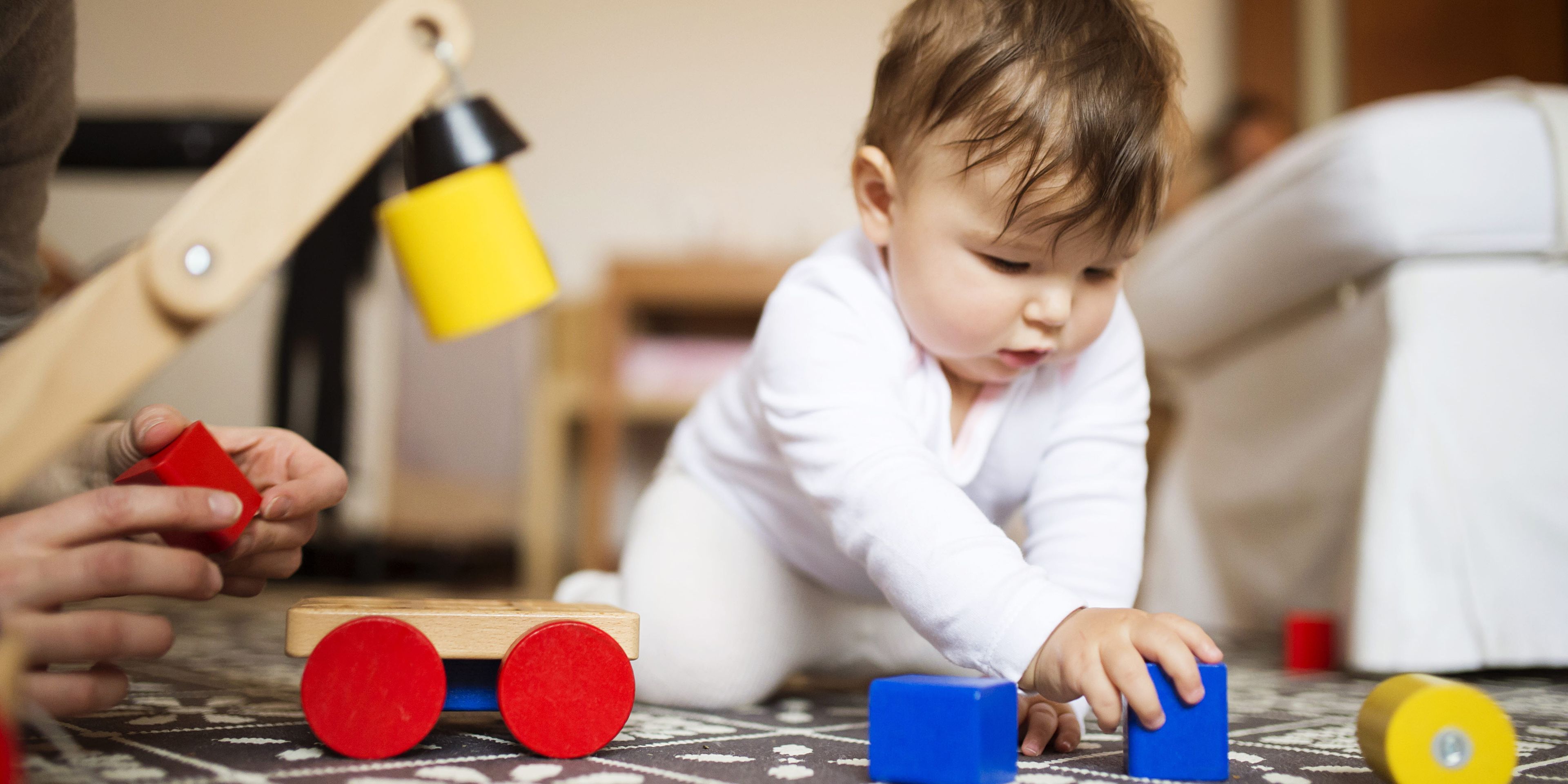 A baby playing with toys on the floor