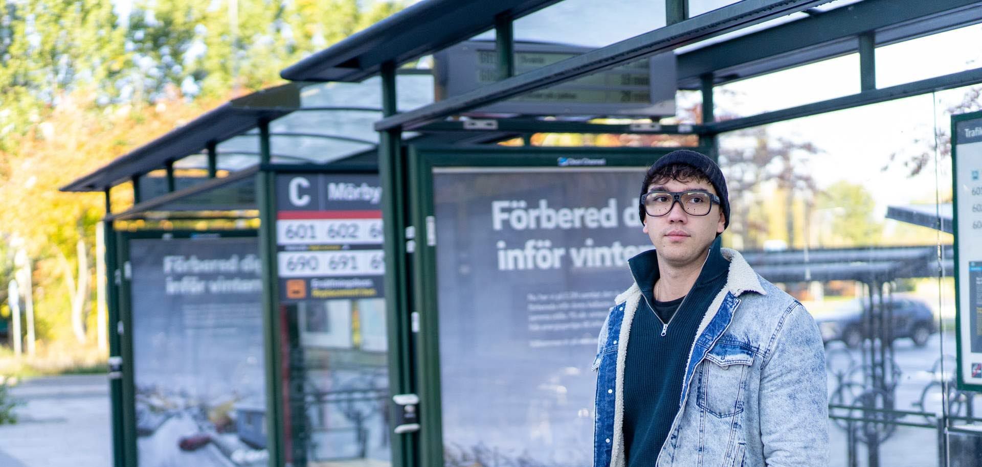 Man using Tobii Pro Glases 3 at a bus stop