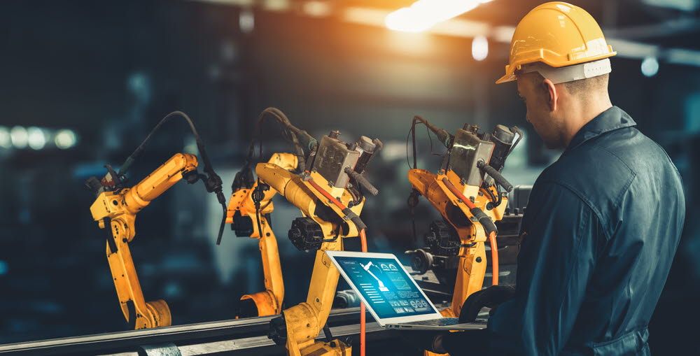 Man operating a computer in a factory.