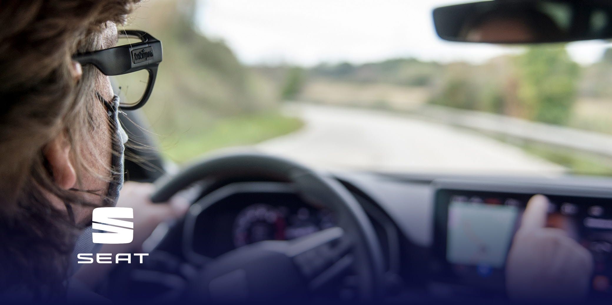 Man driving a car while wearing Tobii Pro Glasses 3