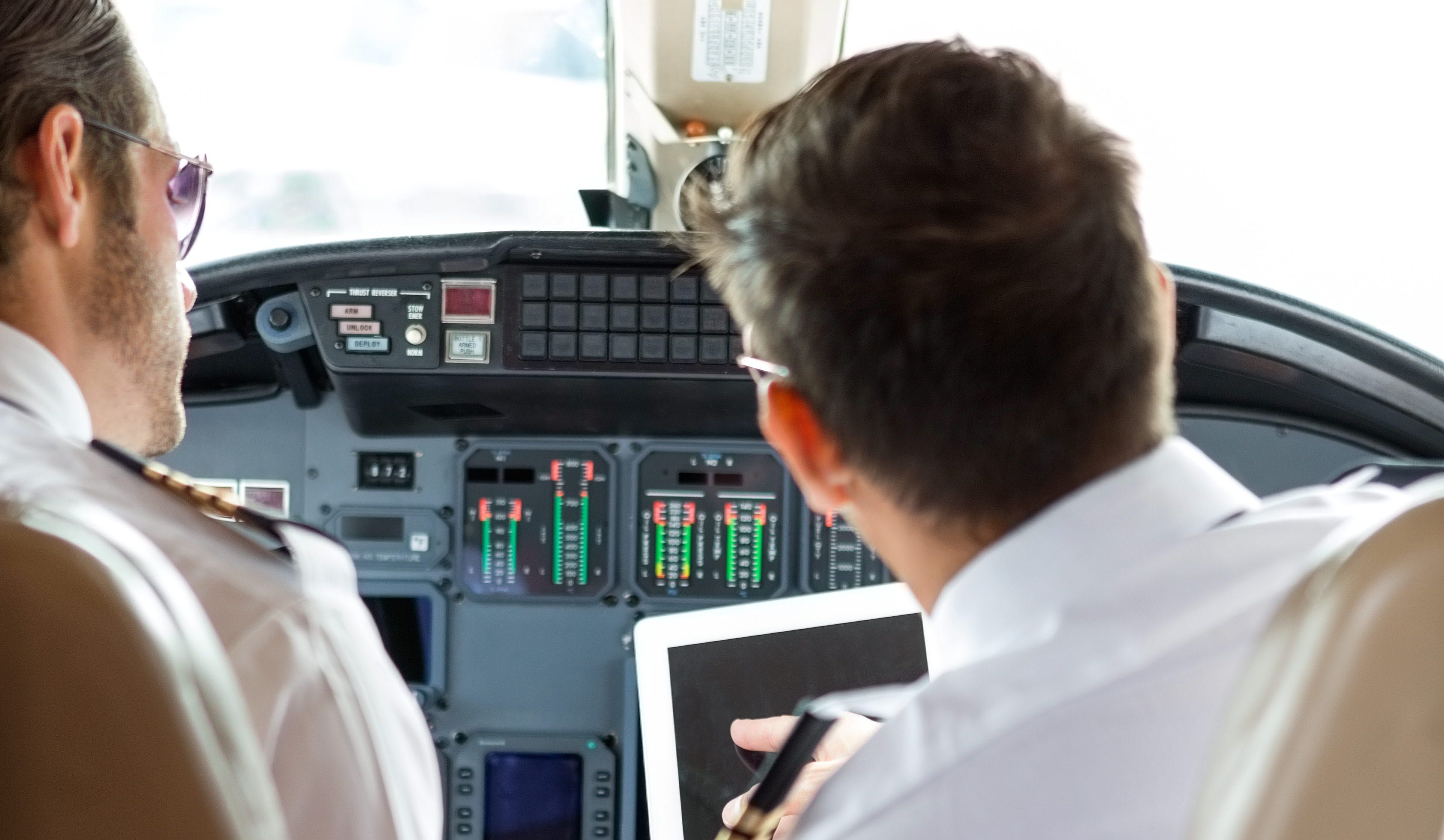 2 pilot doing a safety check in the cockpit