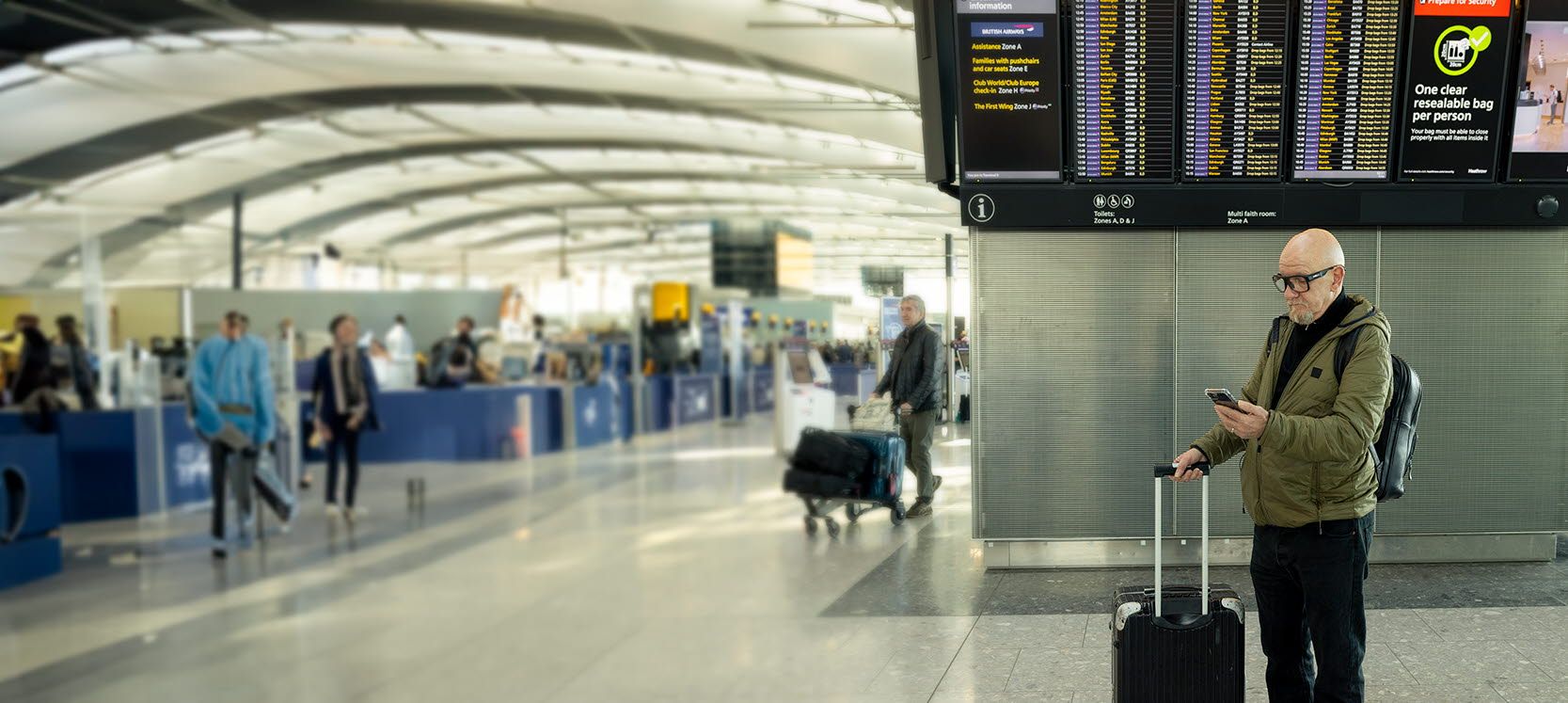 Man near info board at heathrow - Tobii Pro Glasses 3