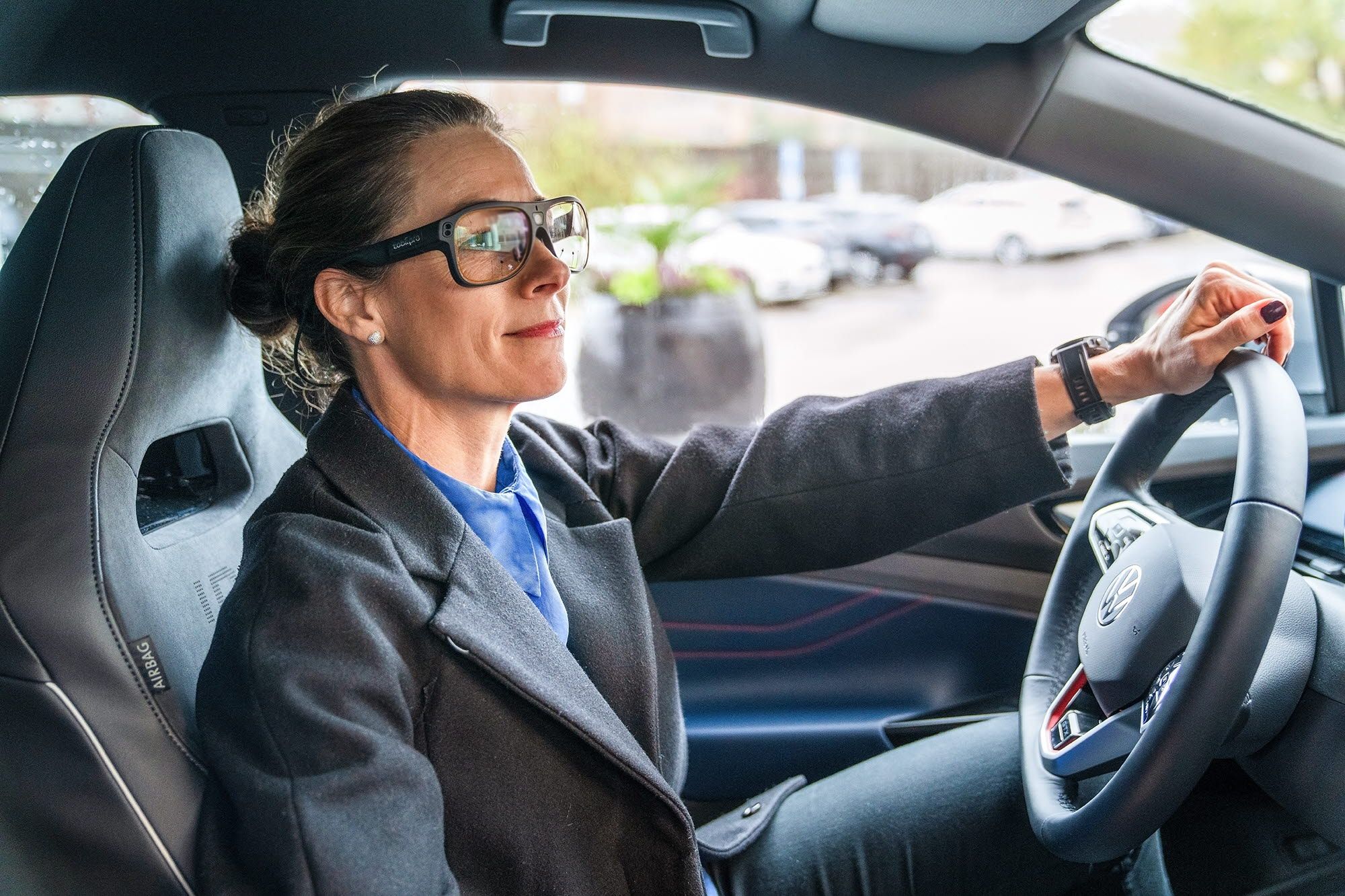 Person driving a car wearing Tobii Pro Glasses 3