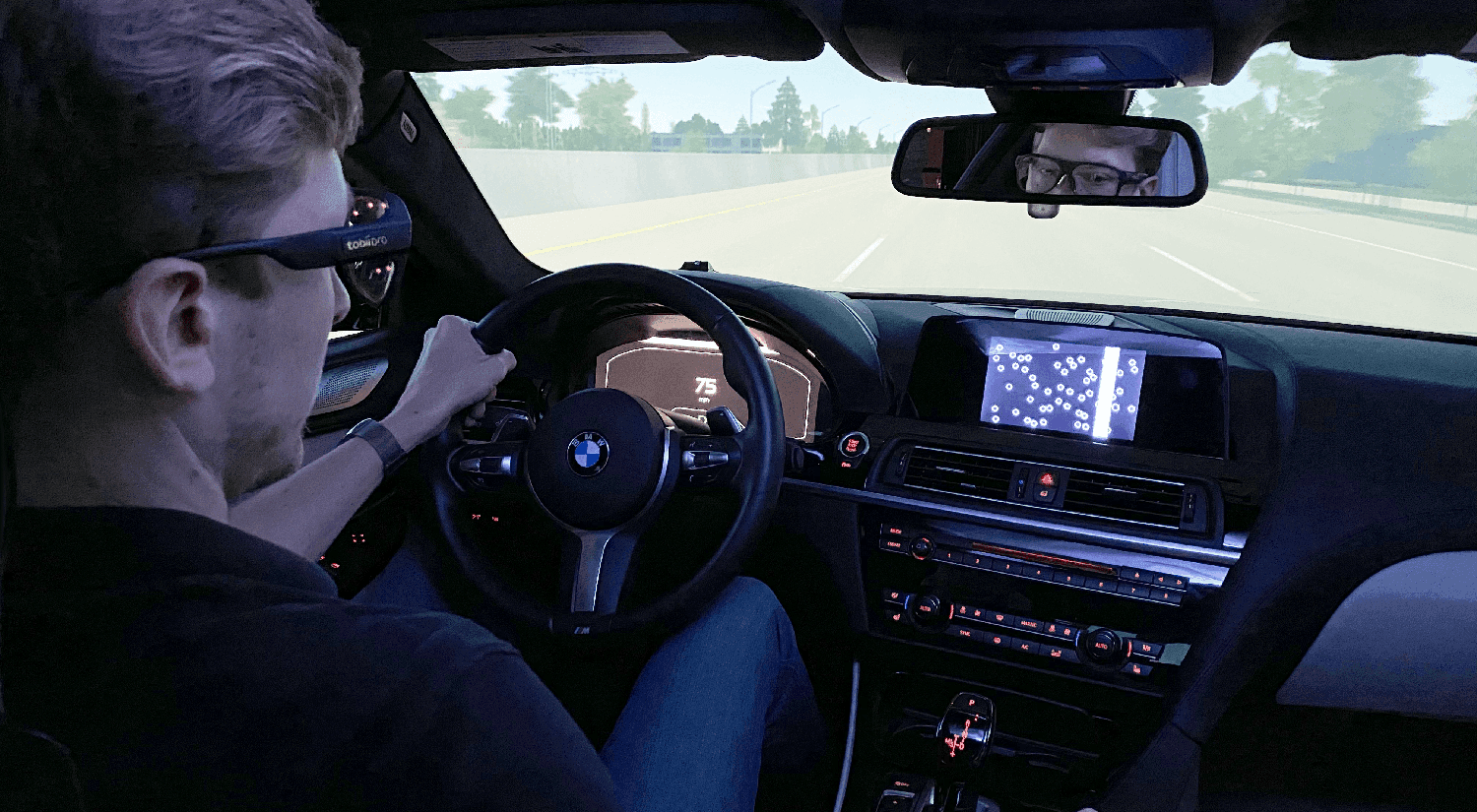 A person driving a car using Tobii Pro Glasses 3