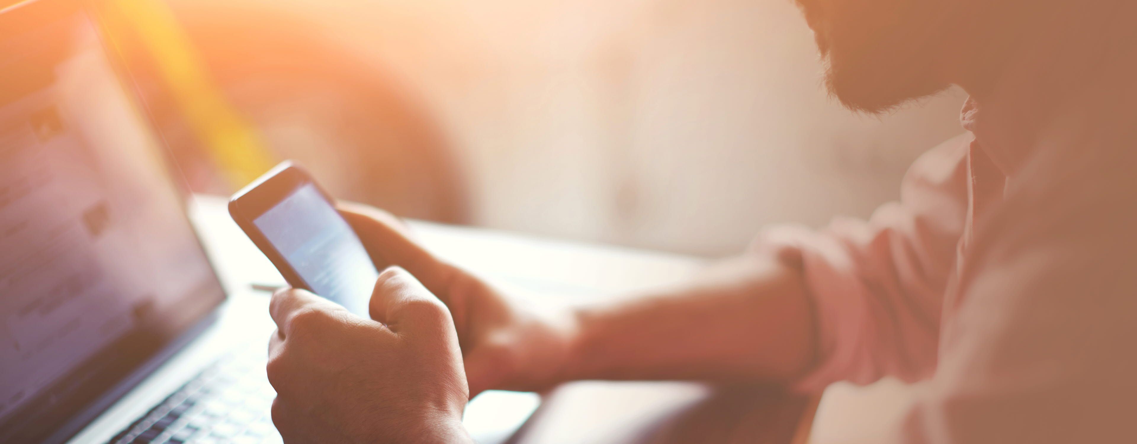 man looking at advertising on mobile phone