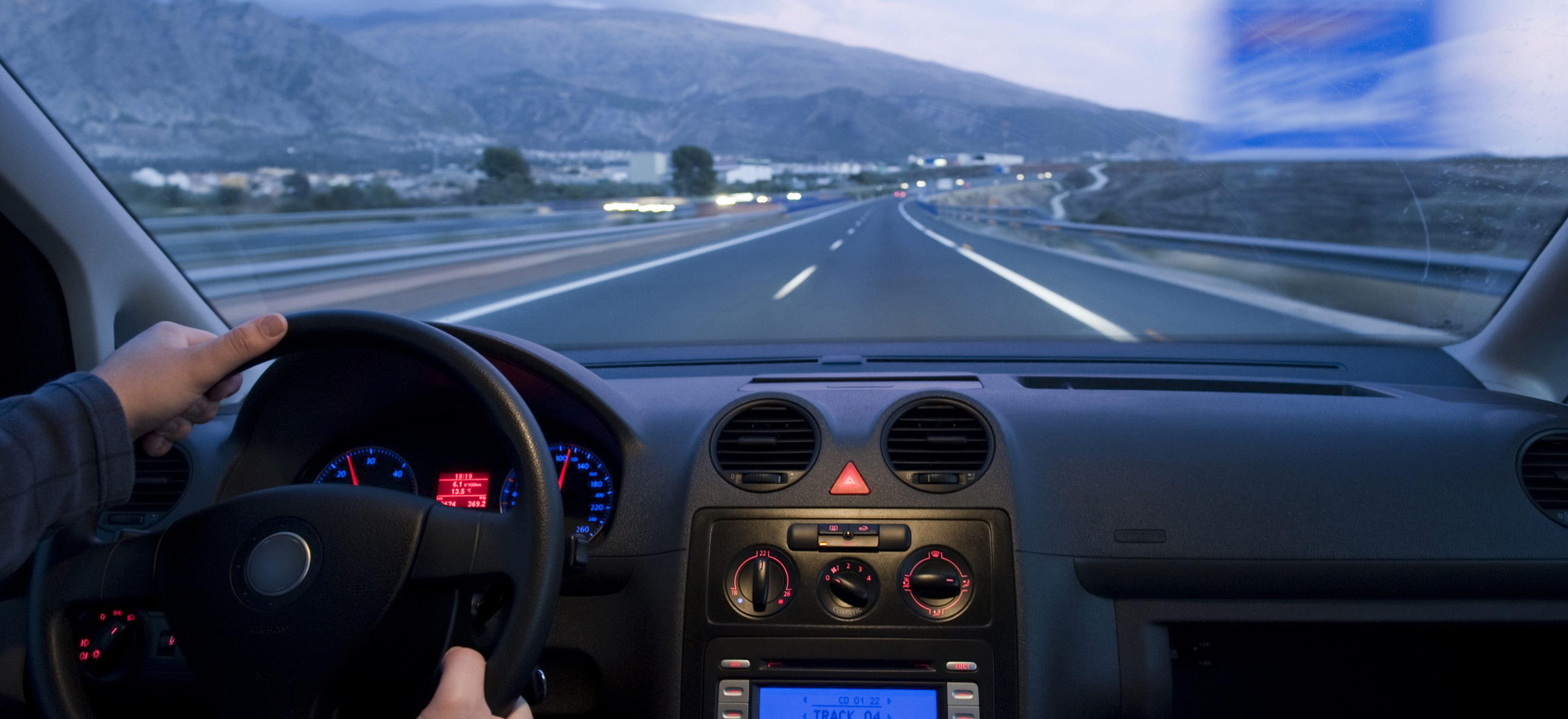 Person driving a car on a highway