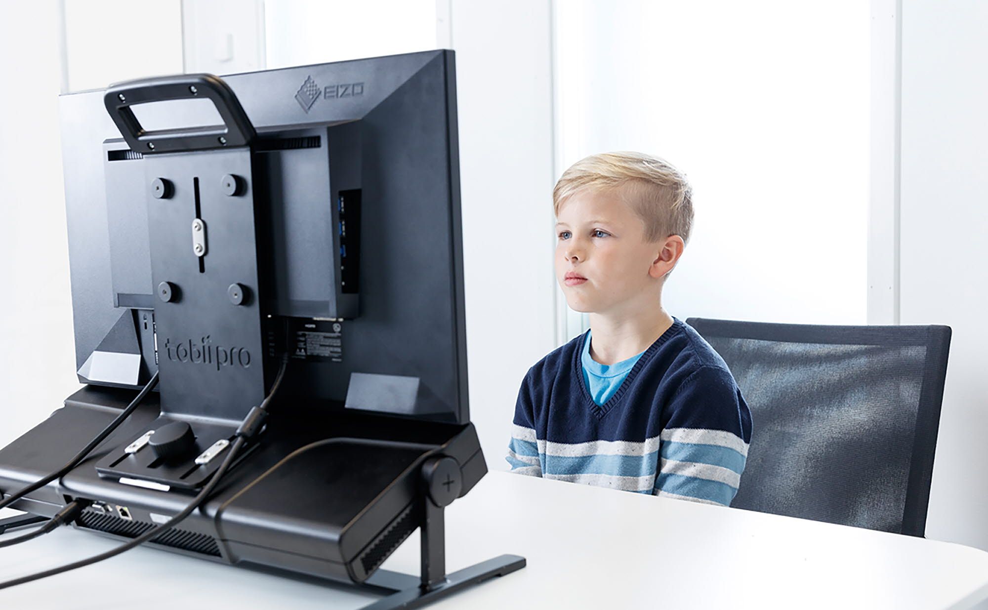 A boy reading on a Tobii Pro Spectrum eye tracker