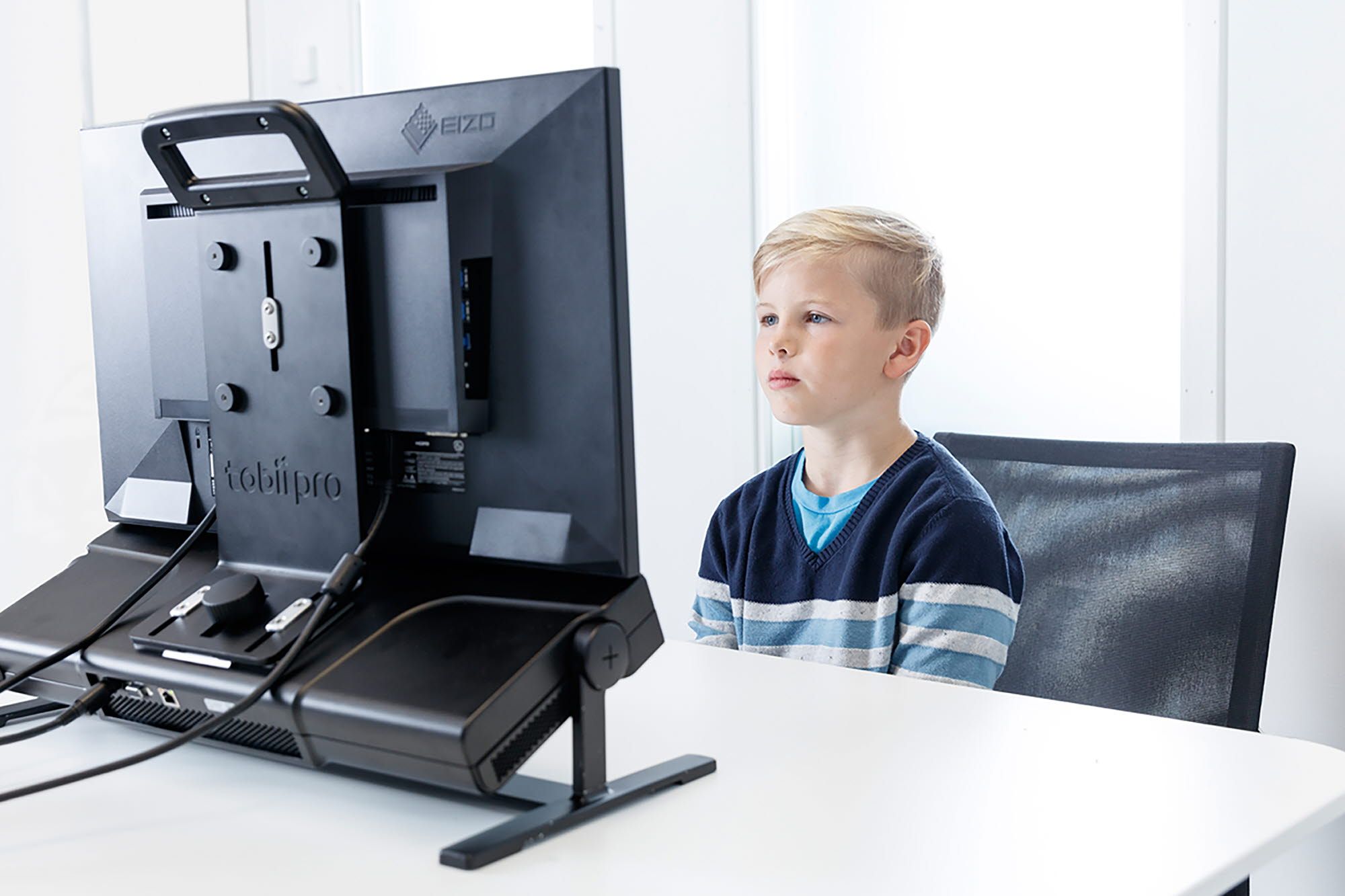 A boy reading on a Tobii Pro Spectrum eye tracker