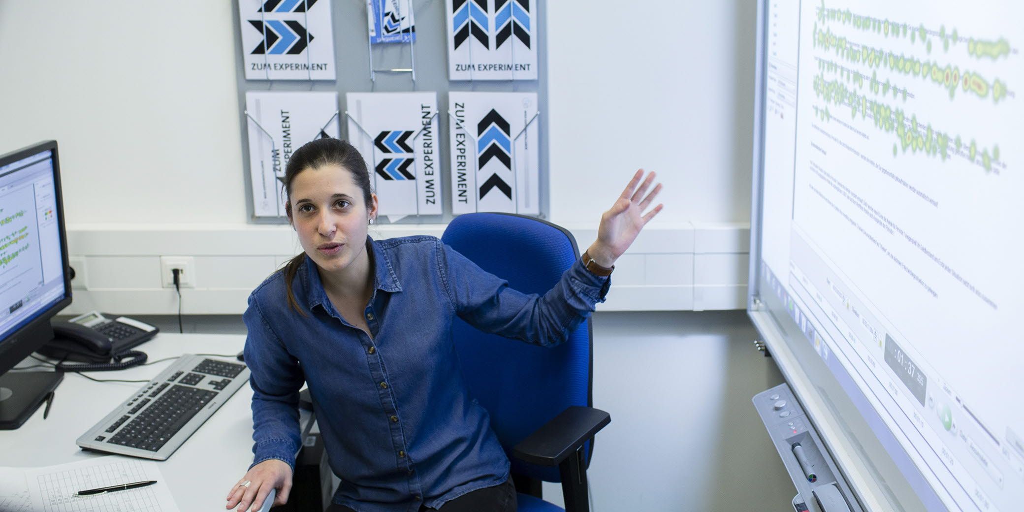 A researcher at the Hamburg University lab point out to a heatmap.