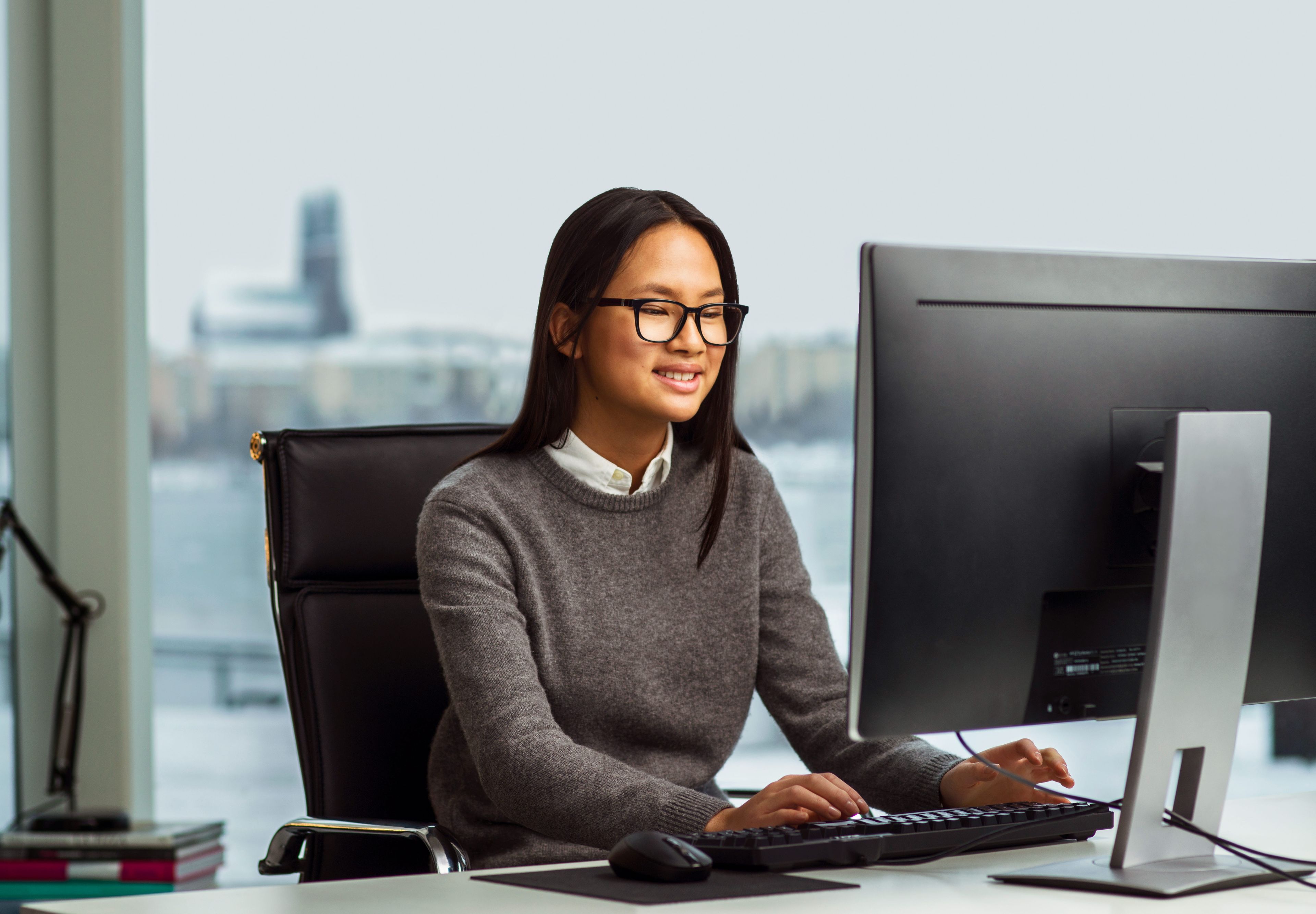 Woman looking at a computer screen with Tobii 4C eye tracker