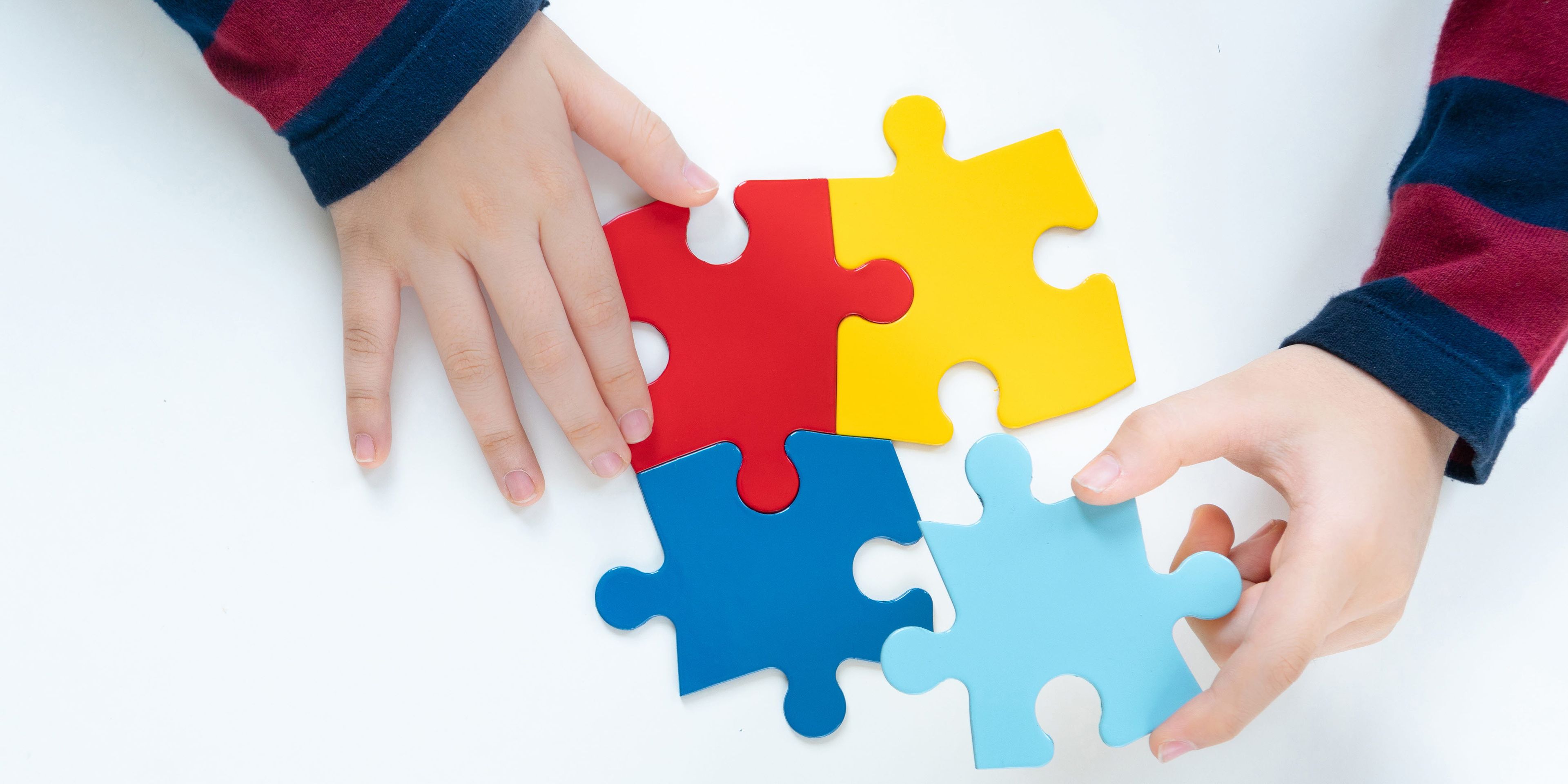 Child playing with puzzle pieces