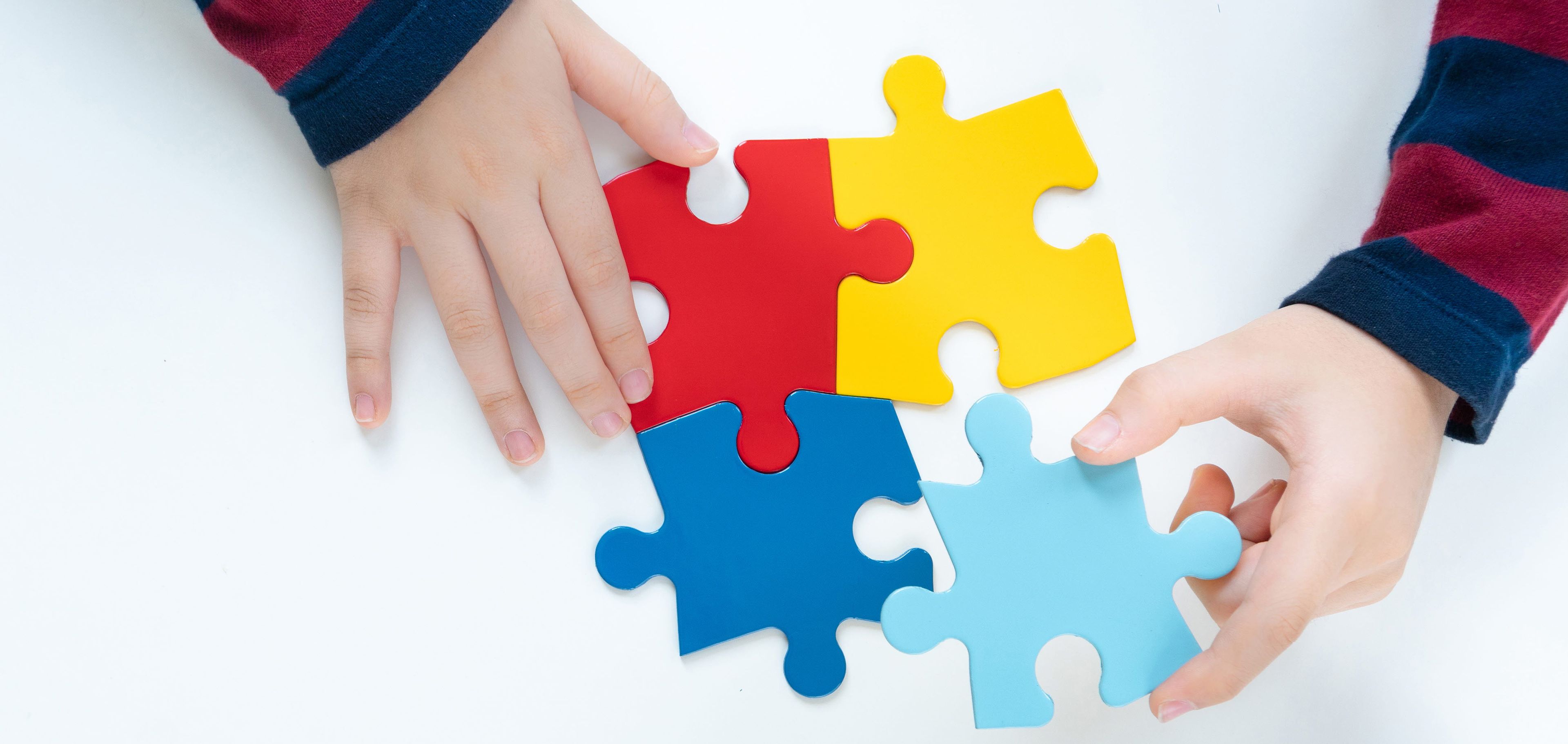 Child playing with puzzle pieces