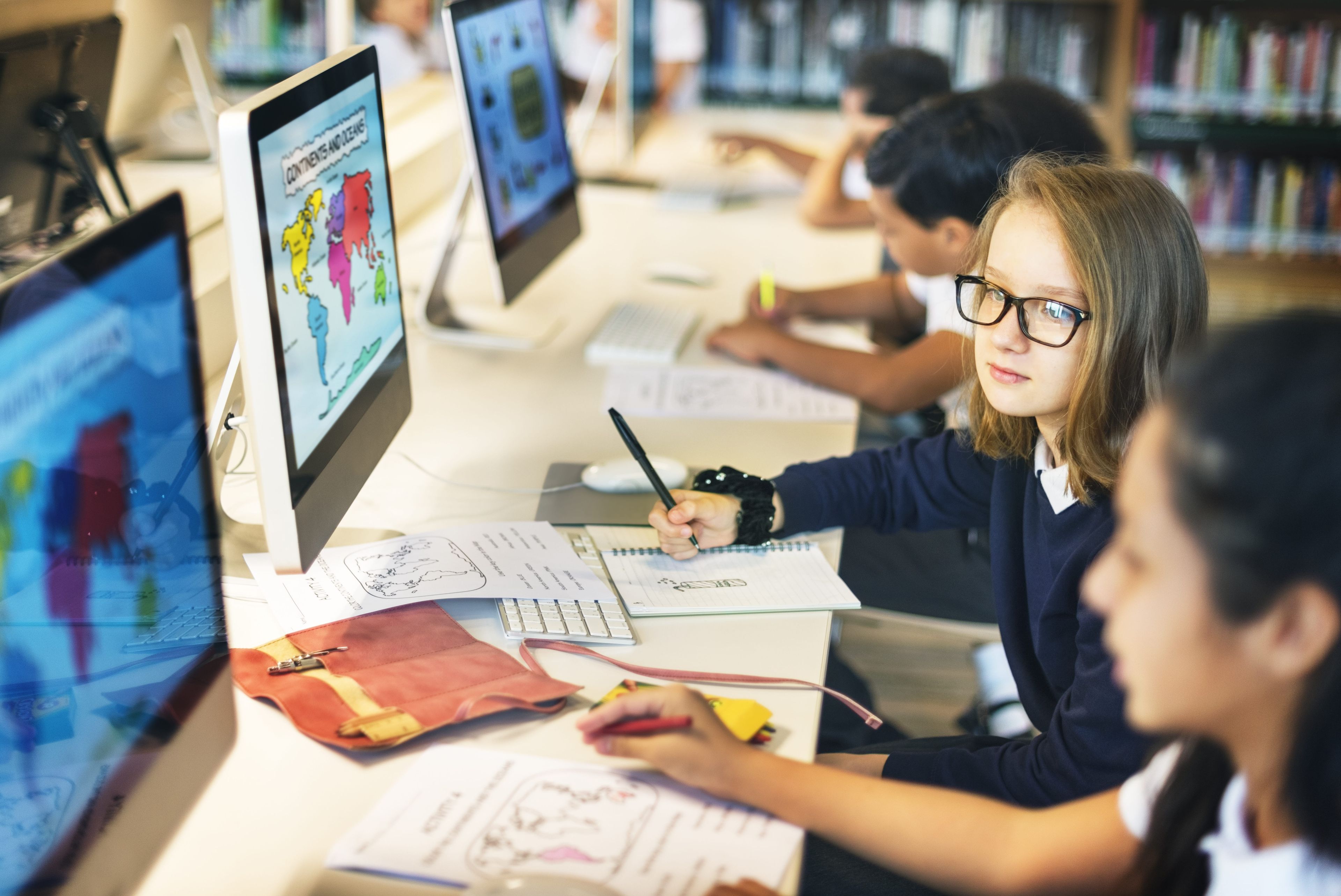 Students learning at computers in classroom